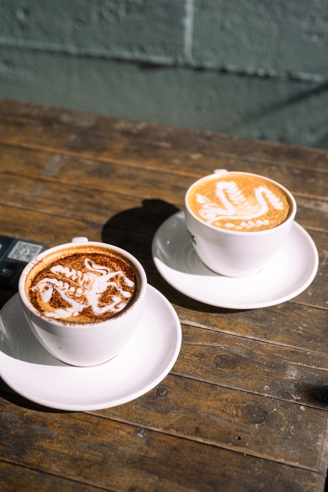Barista pouring latte art at Black Market Training Sydney studio