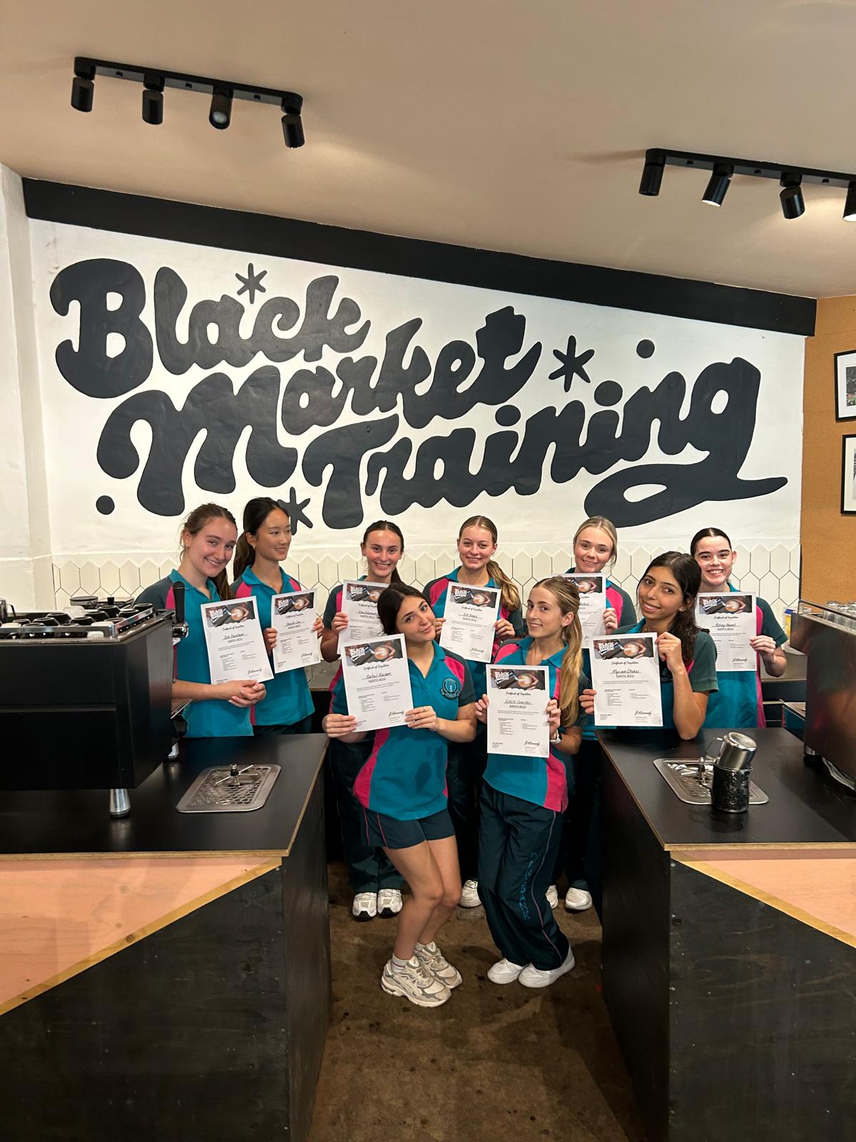 Black Market Training students holding barista certificates after completing their accredited barista course