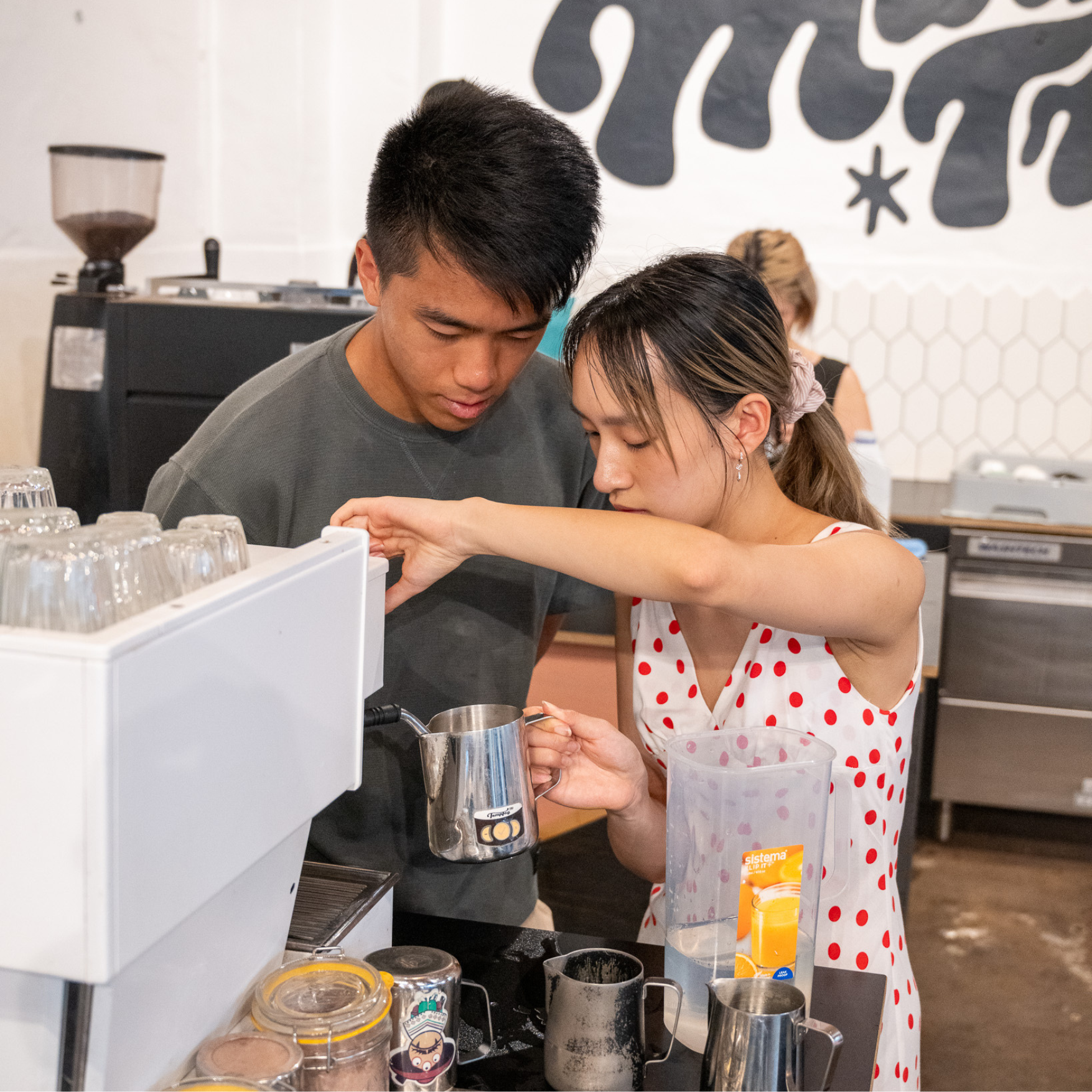 Student operating espresso machine at Black Market barista training Marrickville
