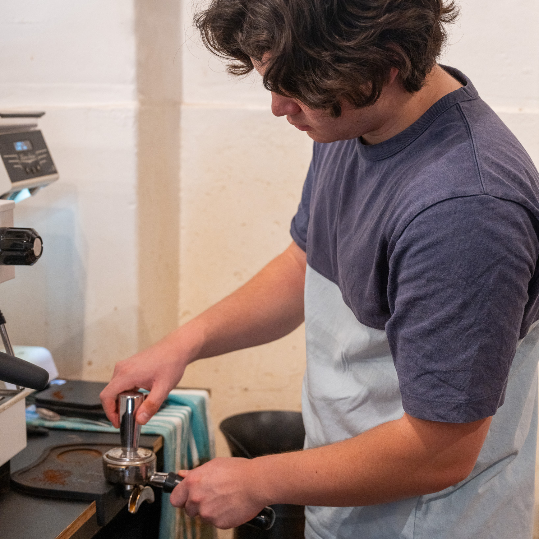 Barista student dialling in espresso during intermediate barista course at BlackMarket Training Sydney