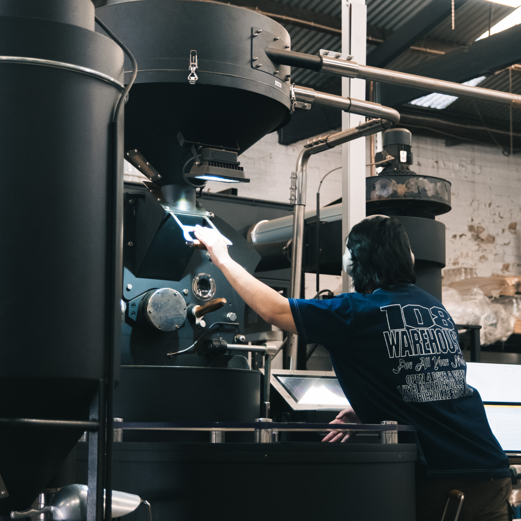 Head roaster at Black Market Training roasting fresh coffee beans on Giesen Machine